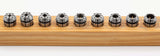 ER External Coolant Collet Sets displayed on a wooden rack, showcasing precision-engineered high-grade spring steel design.